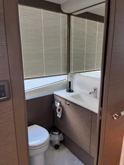  Yacht Photos Pics Modern bathroom in 2023 Princess X80 yacht with sleek design and wooden cabinetry.