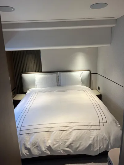  Yacht Photos Pics Luxurious bedroom interior of 2023 Princess X80 yacht with elegant bedding.