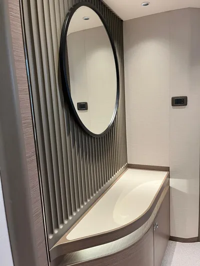  Yacht Photos Pics Modern yacht interior with round mirror and sleek cabinetry, Princess X80, 2023 model.