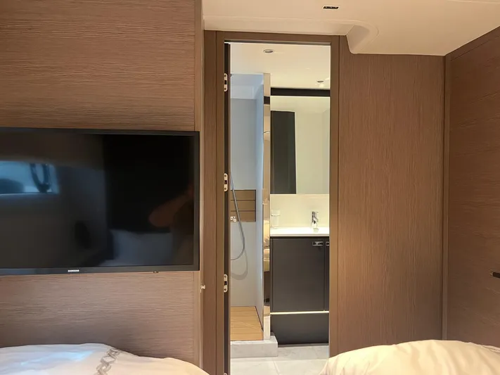  Yacht Photos Pics Interior of 2023 Princess X80 yacht, featuring a modern bathroom and flat-screen TV.