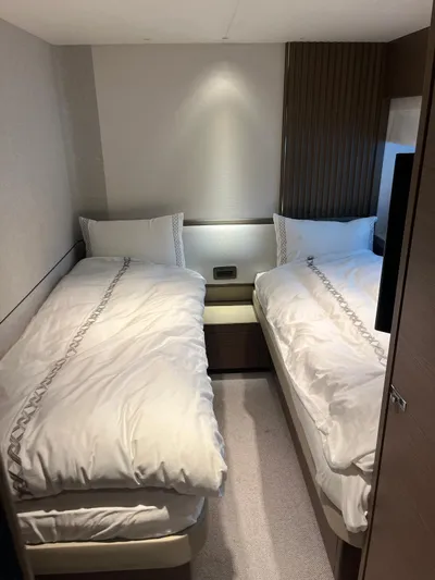  Yacht Photos Pics Luxurious twin bedroom in 2023 Princess X80 yacht, featuring elegant bedding and modern design.