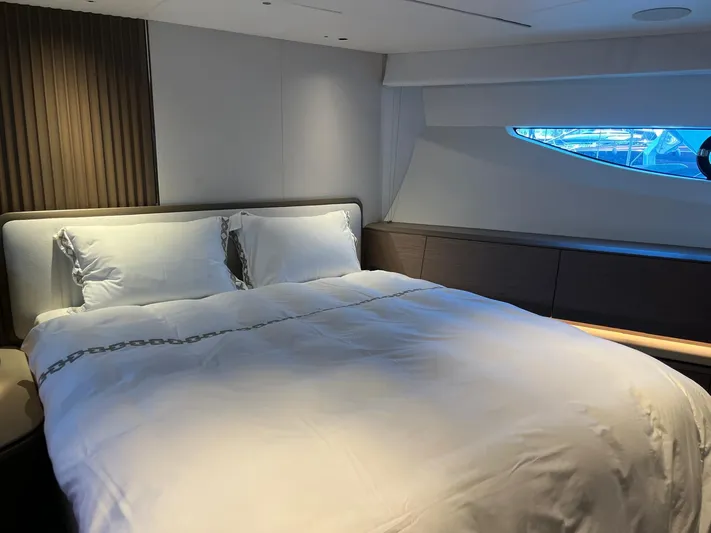  Yacht Photos Pics Luxurious bedroom interior of 2023 Princess X80 yacht with elegant bedding and modern design.