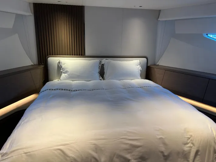  Yacht Photos Pics Luxurious bedroom interior of 2023 Princess X80 yacht with elegant bedding.