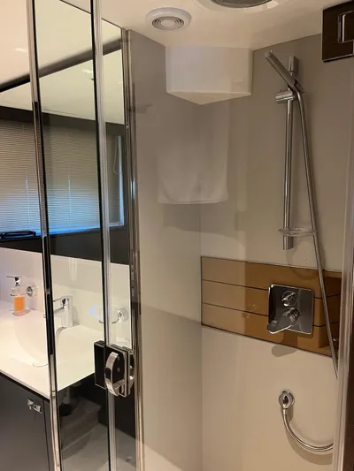  Yacht Photos Pics Modern bathroom in 2023 Princess X80 yacht with glass shower and sleek fixtures.