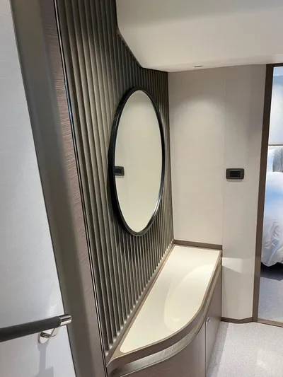  Yacht Photos Pics Modern interior of 2023 Princess X80 yacht with round mirror and sleek design.