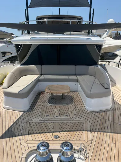  Yacht Photos Pics Luxurious 2023 Princess X80 yacht deck with elegant seating and wooden flooring.