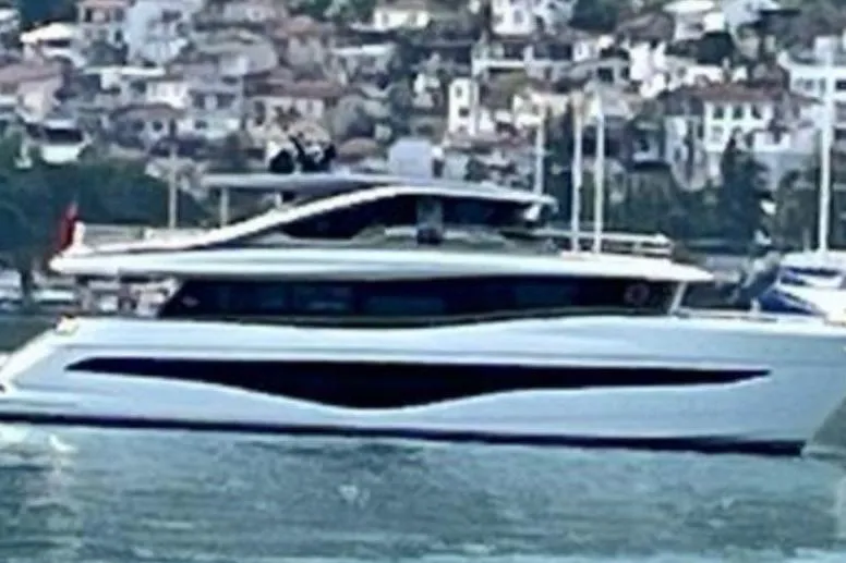  Yacht Photos Pics 2023 Princess X80 yacht cruising near a coastal town.