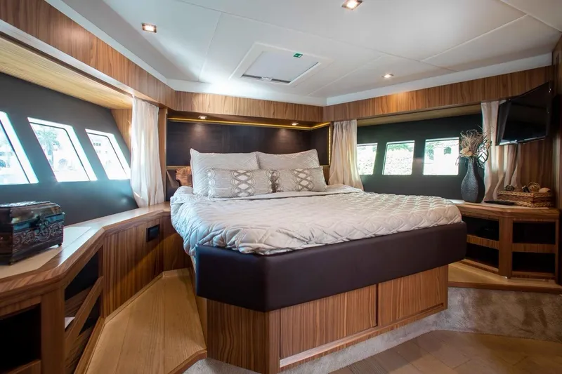  Yacht Photos Pics Luxurious bedroom interior of 2015 Absolute 56 FLY yacht with elegant wood finishes.
