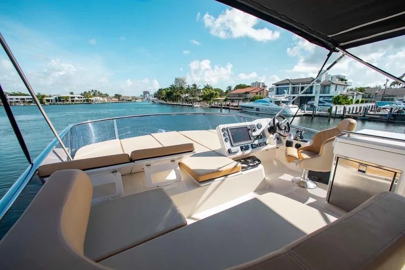  Yacht Photos Pics Flybridge view of 2015 Absolute 56 FLY yacht, featuring luxurious seating and navigation controls.