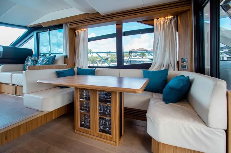  Yacht Photos Pics Luxurious interior of 2015 Absolute 56 FLY yacht with elegant seating and wooden table.