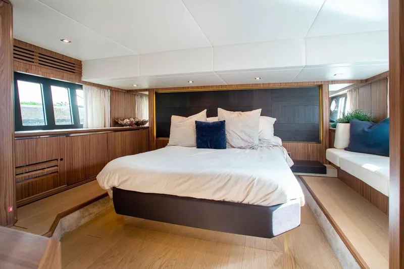  Yacht Photos Pics Luxurious bedroom interior of 2015 Absolute 56 FLY yacht with modern design and cozy ambiance.