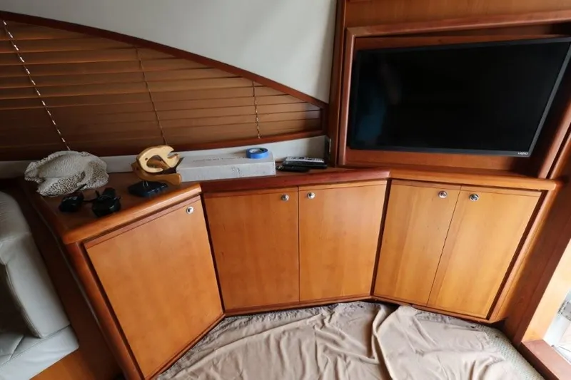 4 Ever Young II Yacht Photos Pics Interior of 2012 Bertram 510 Convertible yacht with wooden cabinets and a mounted TV.