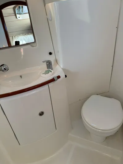 Interlude Yacht Photos Pics Beneteau 393 2002 yacht bathroom with sink, mirror, and toilet.