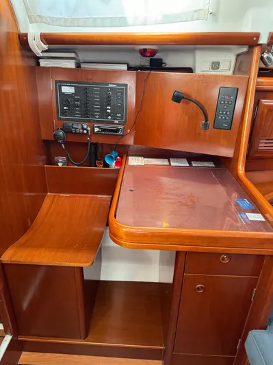 Interlude Yacht Photos Pics Navigation station of 2002 Beneteau 393 sailboat with control panel and wooden finish.