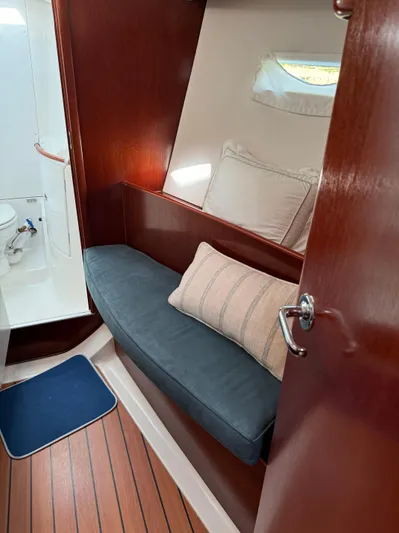 Interlude Yacht Photos Pics Interior of 2002 Beneteau 393 sailboat with wooden finish and cozy seating area.