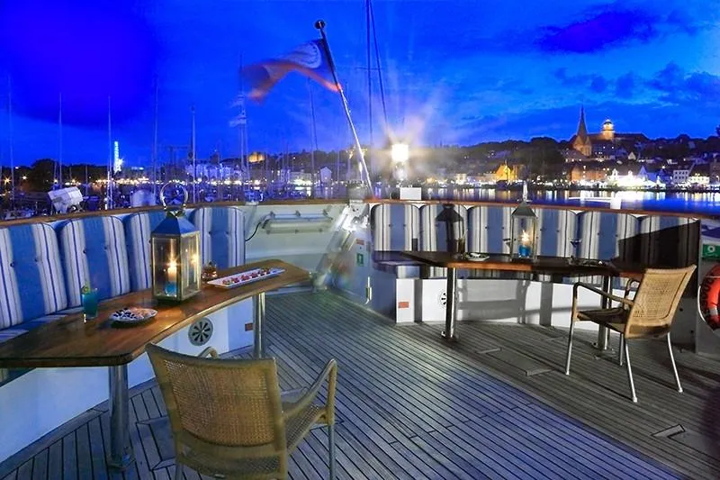 Sanssouci Star Yacht Photos Pics Luxurious yacht deck with seating, lanterns, and scenic harbor view at dusk, 1982 Custom Displacement Twin Screw.