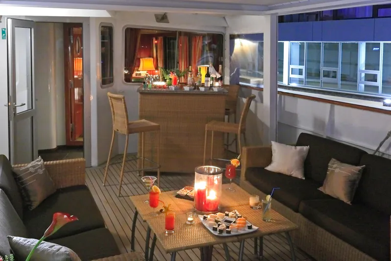 Sanssouci Star Yacht Photos Pics Luxurious yacht interior with cozy seating, bar, and ambient lighting, Custom Displacement Twin Screw, 1982.