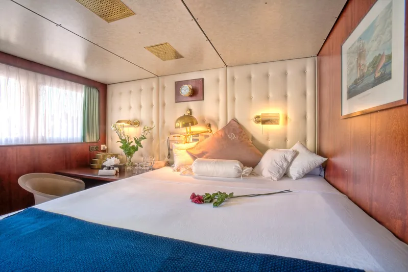 Sanssouci Star Yacht Photos Pics Luxurious cabin interior on 1982 Custom Displacement Twin Screw yacht, featuring elegant bedding and decor.