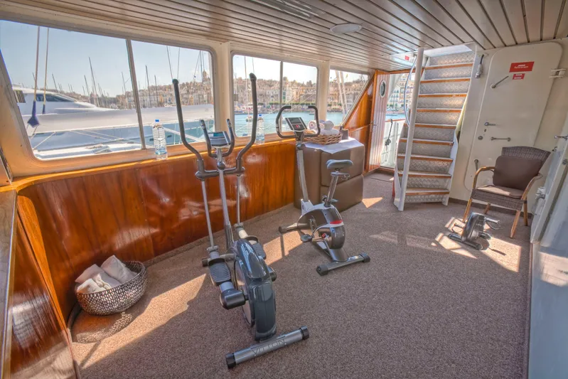 Sanssouci Star Yacht Photos Pics Indoor gym on a 1982 Custom Displacement Twin Screw yacht with exercise bikes and scenic views.