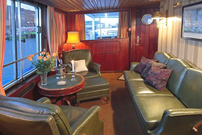 Sanssouci Star Yacht Photos Pics Luxurious 1982 Custom Displacement Twin Screw yacht interior with leather seating and elegant decor.