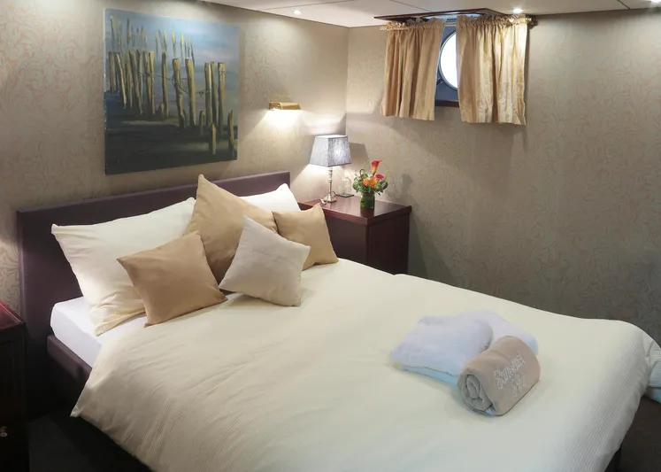 Sanssouci Star Yacht Photos Pics Luxurious bedroom on 1982 Custom Displacement Twin Screw yacht with elegant decor and soft lighting.