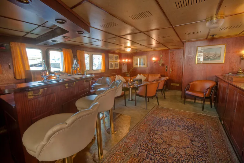 Sanssouci Star Yacht Photos Pics Luxurious yacht interior with bar, seating area, and elegant decor, Custom Displacement Twin Screw, 1982.