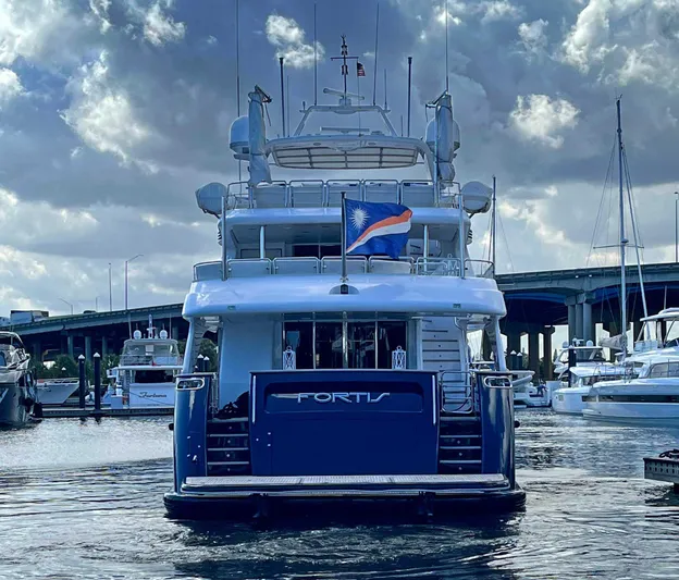 Fortis Benetti 115 Classic Yacht Photos Pics Luxury yacht "Fortis" docked, Benetti 115 Classic, 2003 model, under cloudy sky.