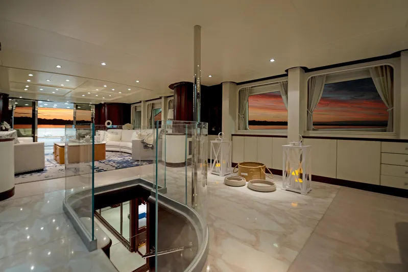 Fortis Benetti 115 Classic Yacht Photos Pics Luxurious interior of 2003 Benetti 115 Classic yacht with elegant furnishings and sunset views.