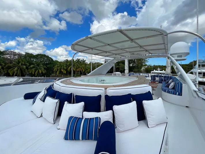 Fortis Benetti 115 Classic Yacht Photos Pics Luxurious 2003 Benetti 115 Classic yacht with sun deck, jacuzzi, and plush seating under blue skies.