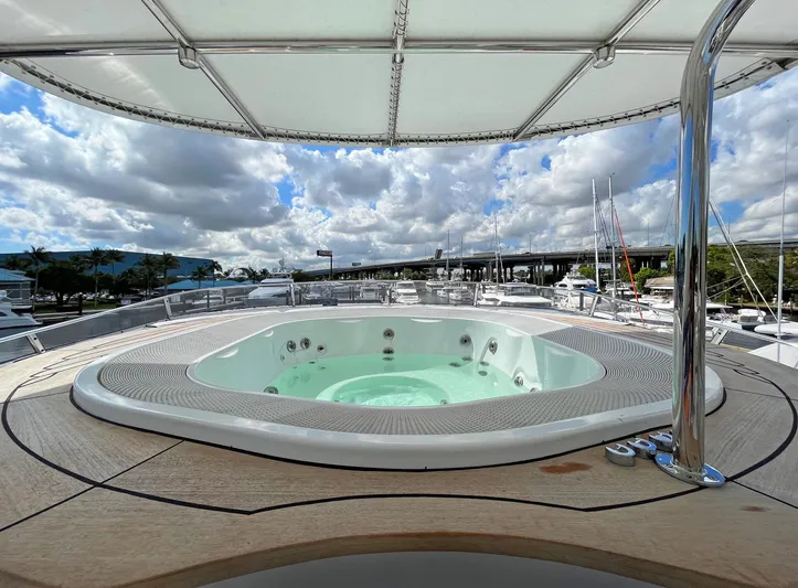 Fortis Benetti 115 Classic Yacht Photos Pics Luxurious jacuzzi on 2003 Benetti 115 Classic yacht under a cloudy sky.