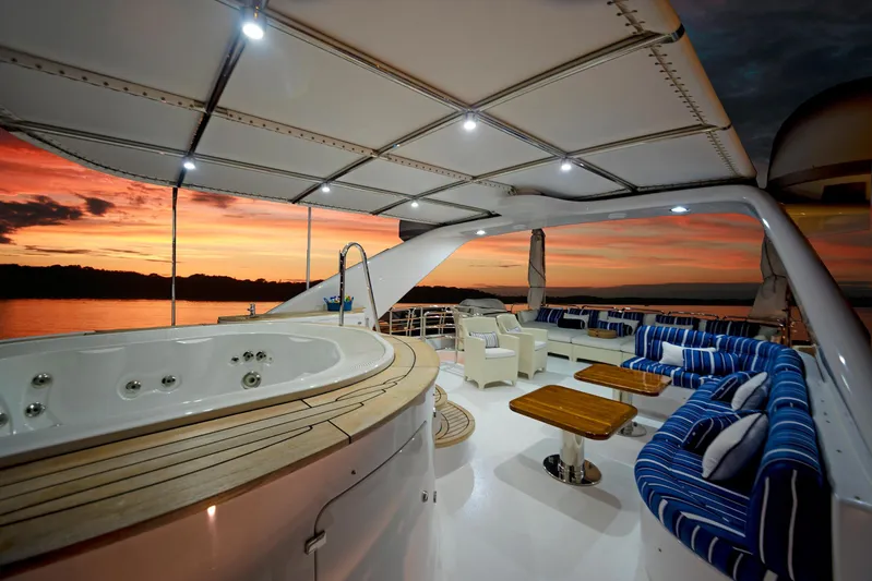 Fortis Benetti 115 Classic Yacht Photos Pics Luxurious 2003 Benetti 115 Classic yacht deck with jacuzzi at sunset.