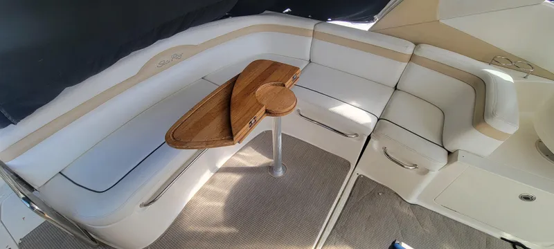  Yacht Photos Pics Interior seating area of a 2008 Sea Ray 350 Sundancer with a wooden table.