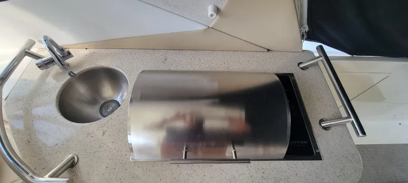  Yacht Photos Pics Sea Ray 350 Sundancer 2008 boat kitchenette with sink and covered stove.