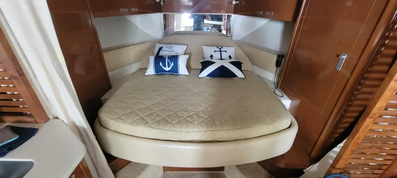  Yacht Photos Pics 2008 Sea Ray 350 Sundancer cabin with bed and nautical-themed pillows.