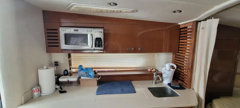  Yacht Photos Pics 2008 Sea Ray 350 Sundancer kitchen with microwave, sink, and storage cabinets.