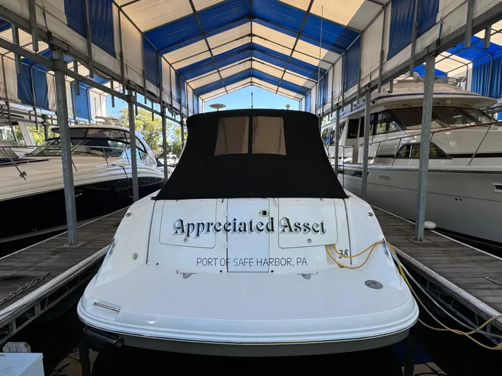 Knot Satisfied Yacht Photos Pics 2006 Sea Ray 38 Sundancer docked at marina, covered and named "Appreciated Asset."