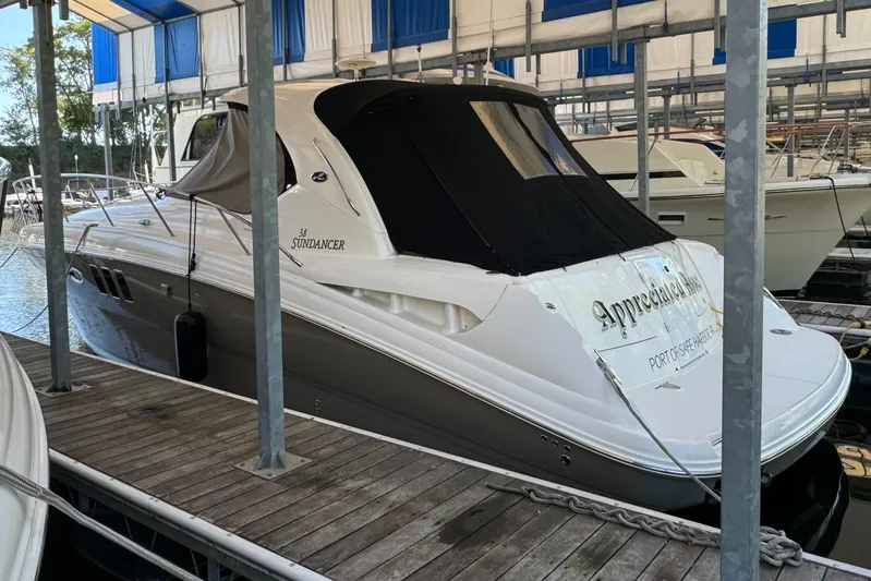 Knot Satisfied Yacht Photos Pics 2006 Sea Ray 38 Sundancer docked in a marina under a covered slip.