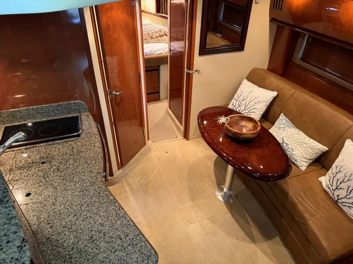 Knot Satisfied Yacht Photos Pics Interior of 2006 Sea Ray 38 Sundancer yacht with elegant seating and kitchenette.