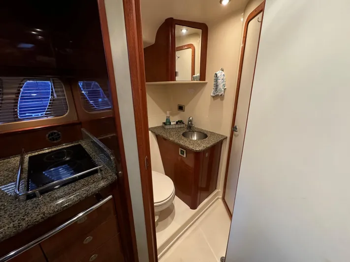 Knot Satisfied Yacht Photos Pics 2006 Sea Ray 38 Sundancer bathroom with granite countertops and wood cabinetry.