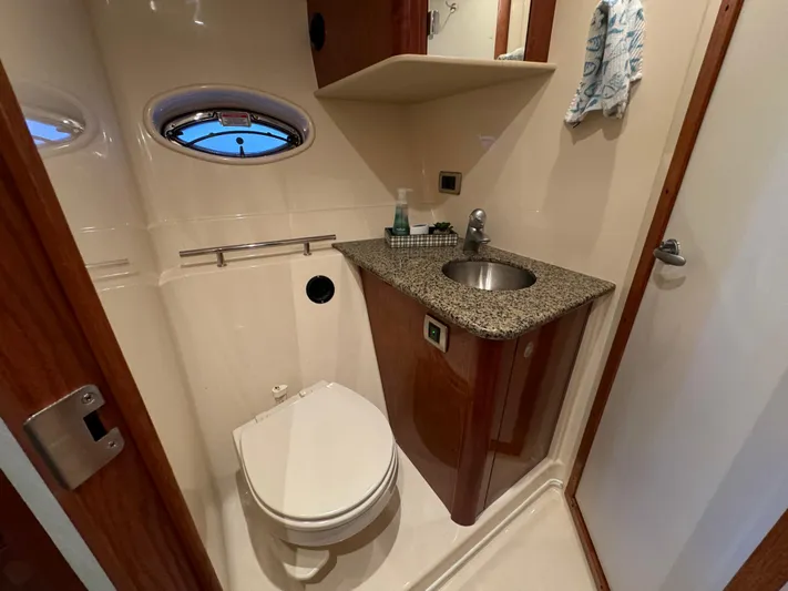Knot Satisfied Yacht Photos Pics Bathroom interior of 2006 Sea Ray 38 Sundancer yacht with sink and toilet.