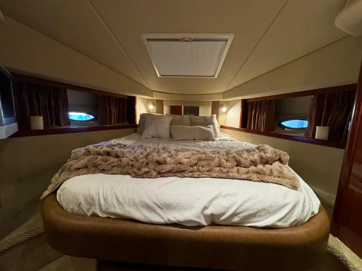 Knot Satisfied Yacht Photos Pics Luxurious cabin interior of 2006 Sea Ray 38 Sundancer yacht with cozy bedding.