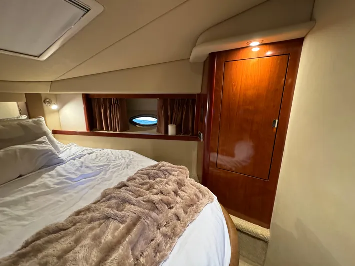 Knot Satisfied Yacht Photos Pics Luxurious cabin interior of 2006 Sea Ray 38 Sundancer with cozy bedding and wooden cabinetry.