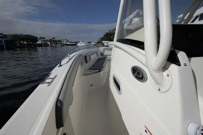  Yacht Photos Pics 2001 Pursuit 3070 Center Console boat on calm water, showcasing sleek design and spacious deck.
