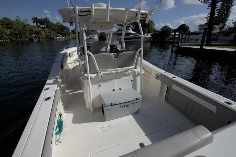  Yacht Photos Pics 2001 Pursuit 3070 Center Console boat on calm water, featuring spacious deck and seating.