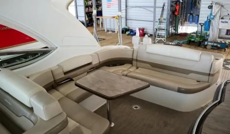  Yacht Photos Pics 2016 Formula 400 Super Sport yacht interior with beige seating and table in a marina setting.
