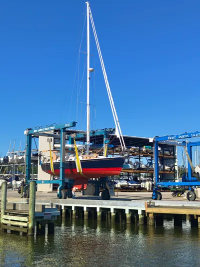 Bella Yacht Photos Pics Sailboat Tartan 4300, 2018 model, in a yacht yard lift, clear blue sky.