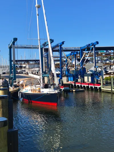 Bella Yacht Photos Pics Sailboat Tartan 4300 (2018) docked at marina with blue sky backdrop.