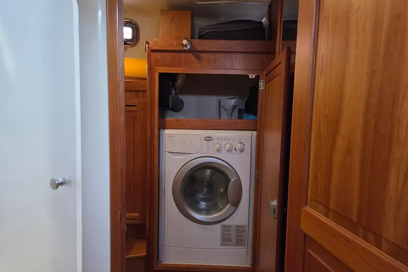 Bella Yacht Photos Pics Laundry area with washing machine in 2018 Tartan 4300 yacht interior.