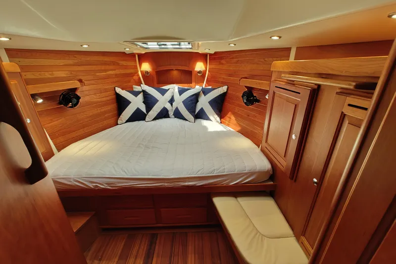 Bella Yacht Photos Pics Luxurious 2018 Tartan 4300 yacht cabin with wood paneling and cozy bedding.