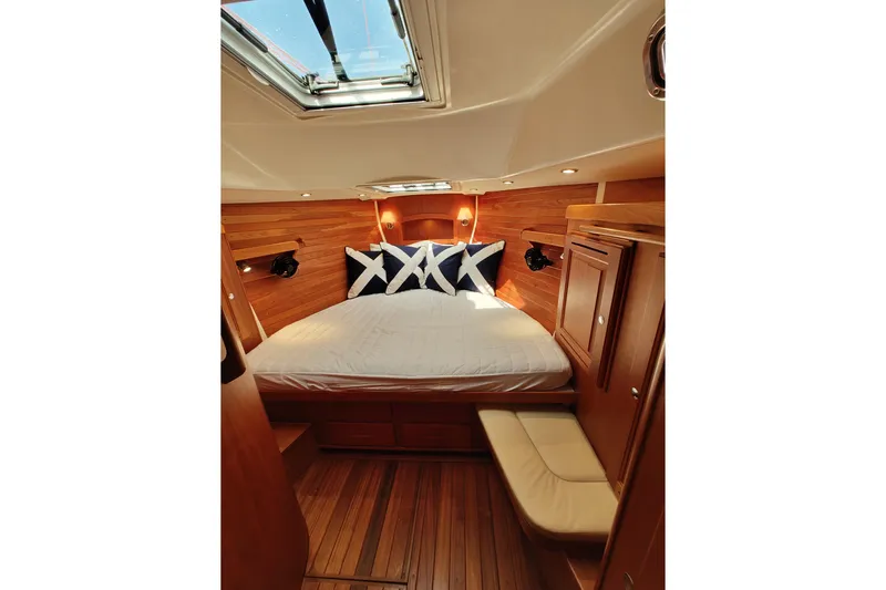 Bella Yacht Photos Pics Luxurious 2018 Tartan 4300 yacht cabin with wood paneling and skylight.